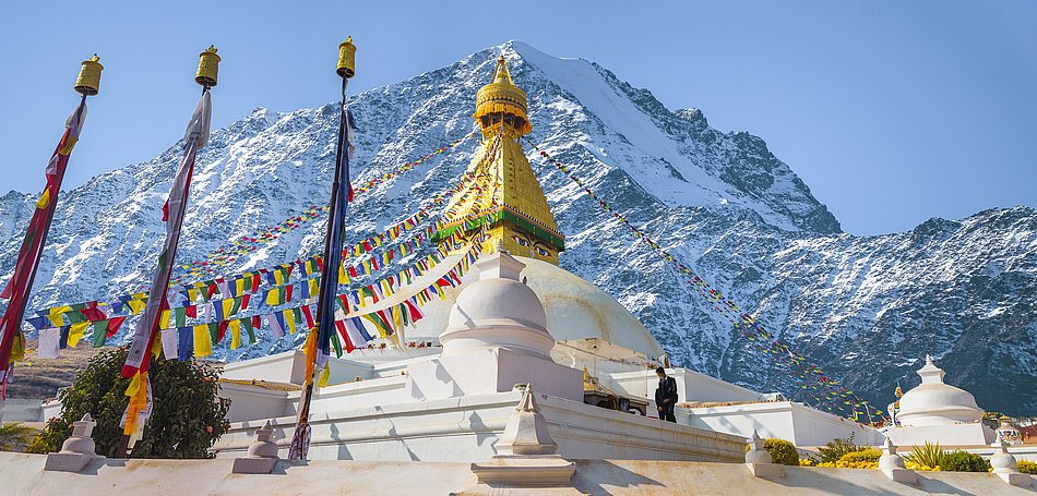 A Nepalese building in front of a large mountain